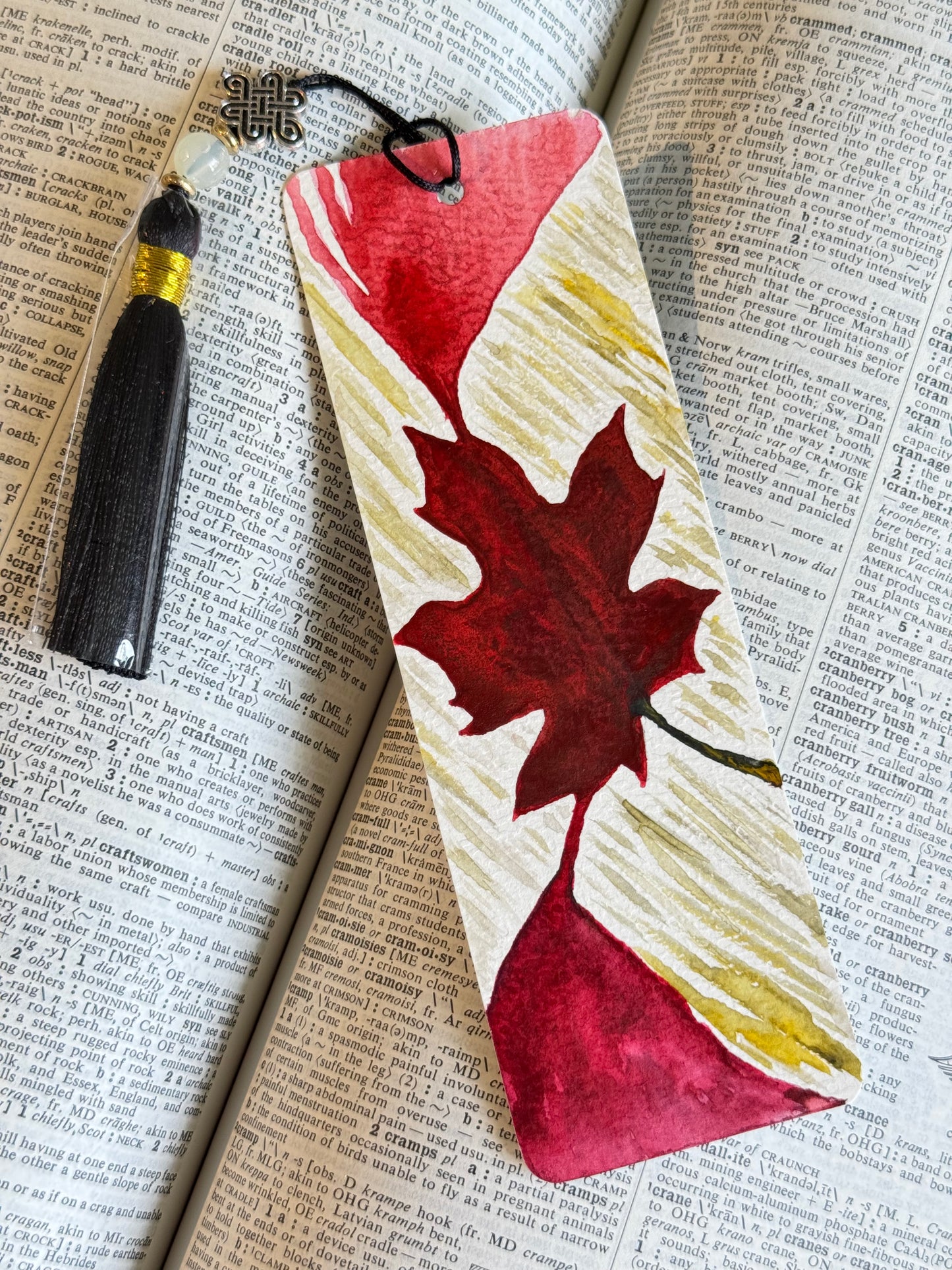 Red maple leaf bookmark in book
